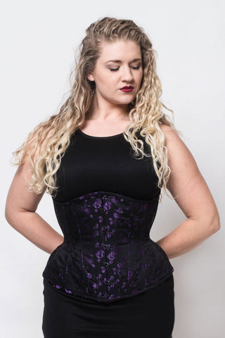 Purple rosebud coutil corset by The Bad Button is a purple fabric with delicate purple floral detailing