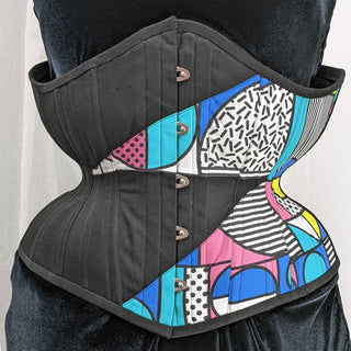 A Bad Button bespoke corset design by Alisha Martin featuring a black fabric and geometric 80s style print