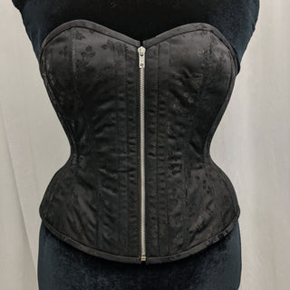 A Bad Button bespoke corset design by Alisha Martin featuring a front zip detail and minimal flower pattern on black satin