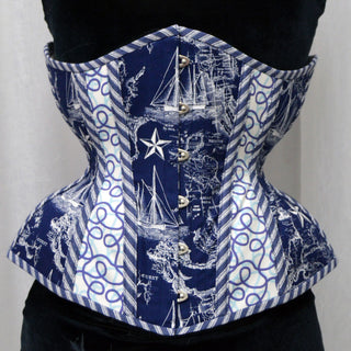 A Bad Button bespoke corset design by Alisha Martin featuring panels of various blue fabrics in a nautical theme