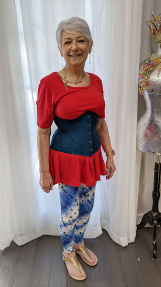 A Bad Button bespoke corset design by Alisha Martin being worn on an older lady with fair skin