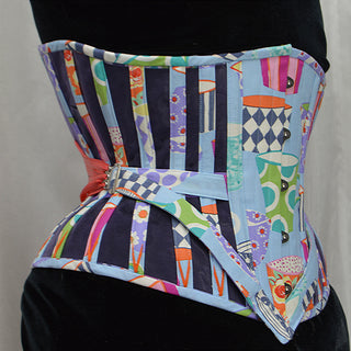A Bad Button bespoke corset design by Alisha Martin featuring a colorful coffee cup fabric, blue panelling and bright pink lacing