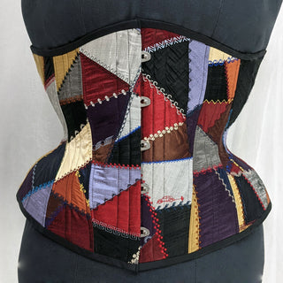 A Bad Button bespoke corset design by Alisha Martin featuring a patchwork of quilt-like embellishment and visible stitching