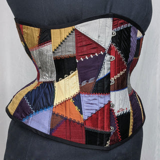 A Bad Button bespoke corset design by Alisha Martin featuring a patchwork of quilt-like embellishment and visible stitching