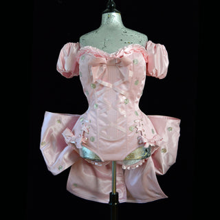 A Bad Button bespoke corset design by Alisha Martin featuring a pink ensemble wit many ruffles and gold spot embellishments