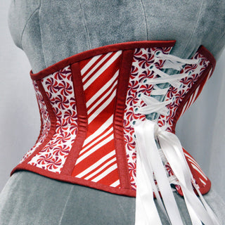 A Bad Button bespoke corset design by Alisha Martin featuring candy peppermint fabric alternated with red and white candy cane fabric