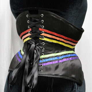 A Bad Button bespoke corset design by Alisha Martin featuring rainbow ribbon detailing on a black background for a pride corset