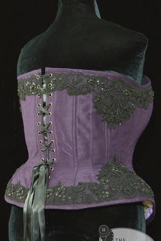 A Bad Button bespoke corset design by Alisha Martin featuring a deep purple base and black beaded lace detailing