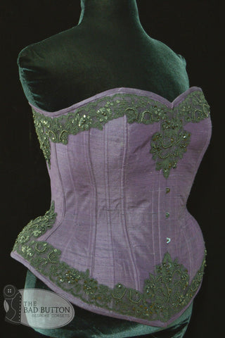 A Bad Button bespoke corset design by Alisha Martin featuring a deep purple base and black beaded lace detailing