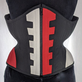 A Bad Button bespoke corset design by Alisha Martin featuring a central zip and red, black and grey structuing