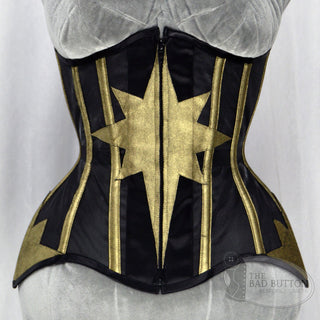 A Bad Button bespoke corset design by Alisha Martin featuring gold star detailing on a satin background
