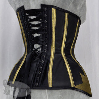 A Bad Button bespoke corset design by Alisha Martin featuring gold star detailing on a satin background