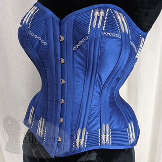 A Bad Button bespoke corset design by Alisha Martin featuring a deep blue base and silver stitch detailing