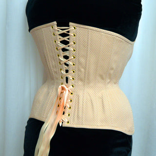 A Bad Button bespoke corset design by Alisha Martin featuring a lemon yellow fabric with delicate spot
