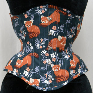 A Bad Button custom corset design by Alisha Martin featuring a fabric with cartoon red pandas and flower motifs